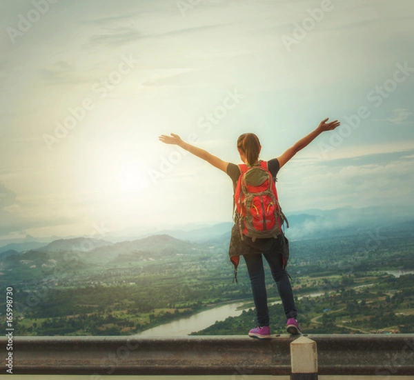 Obraz cheering successful woman hiker open arms on mountain top.Young woman enjoying the fresh air.