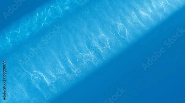 Fototapeta Diagonal Light Beams on Vibrant Blue Textured Surface with Wave Pattern