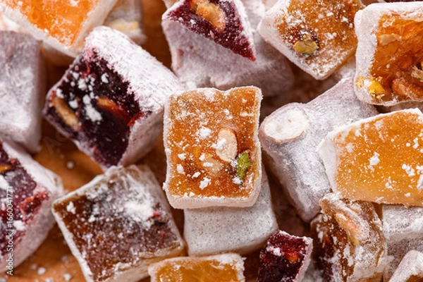Fototapeta Sweet food Turkish delight, assorted rahat locum in form of cubes with nuts and powdered sugar, traditional food