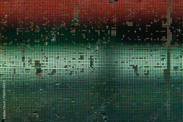 Fototapeta wet insect screen with rain drops at the window in the night