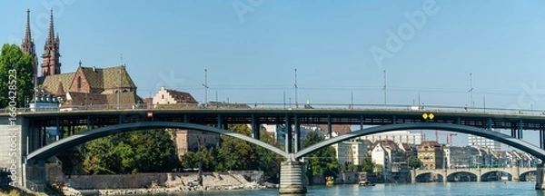 Fototapeta Panoramic view of the bridge and Basel Cathedral from the river