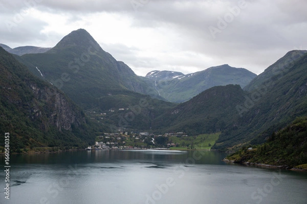 Fototapeta Views of famous Geirangerfjord in Norway, during cruise by ship. Buildings of Geiranger village on coast.