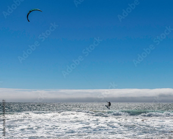 Fototapeta Lompoc, CA, USA – August 13, 2025: Kitesurfers take advantage of the high winds on the Pacific Ocean at Jalama Beach in Lompoc, CA.