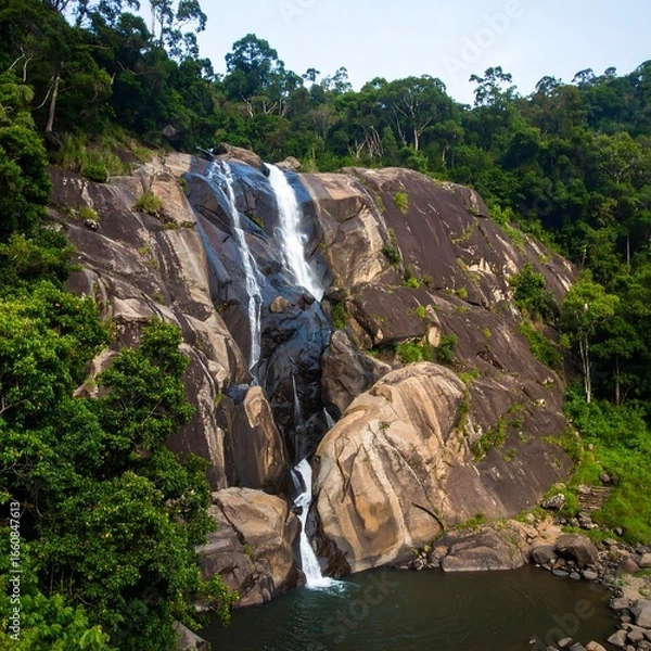 Fototapeta Majestic waterfall cascading into a tranquil pool, surrounded by lush green forest