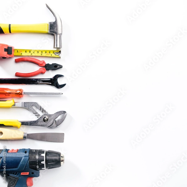 Fototapeta Top view of Working tools,wrench,socket wrench,hammer,screwdriver,plier,electric drill,tape measure,machinist square on white background. flat lay