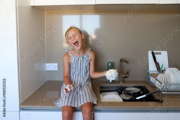 Obraz Smiling girl sitting on counter with foam in hands