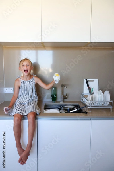 Obraz Girl having fun with sponge and bubbles during dishwashing