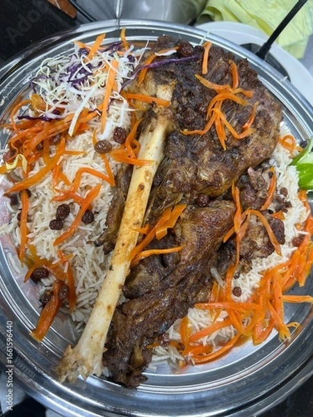 Obraz Kabuli pulao luxurious pilaf Afghan national dish closeup on the plate on the wooden table. Horizontal top view from above