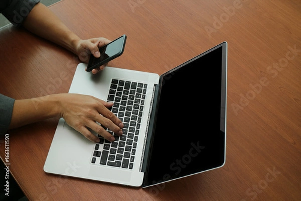 Fototapeta Businessman Working with Laptop and Smartphone