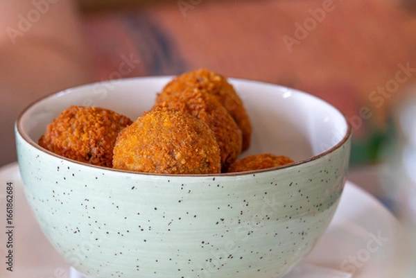 Obraz golden brown deep fried bitterballs mini krokets in a bowl on a cafe table close up