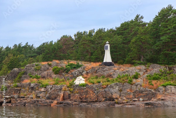 Fototapeta Solar-powered marine marker installed on the shore. Sustainable navigation aid in coastal waters of Baltic sea, symbolizing safety, renewable energy, and environmental responsibility