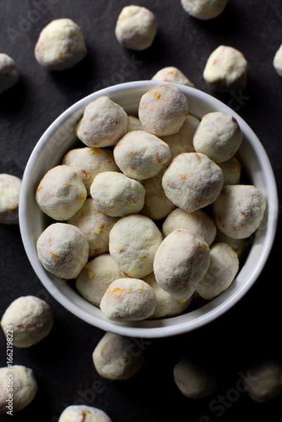 Obraz Powdered milk gourmet popcorns in a bowl in dark slate background seen from above