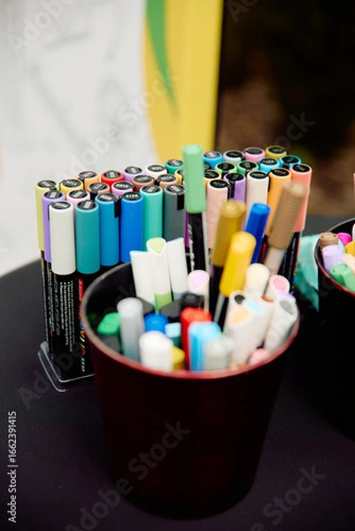 Fototapeta Colorful markers arranged on black table