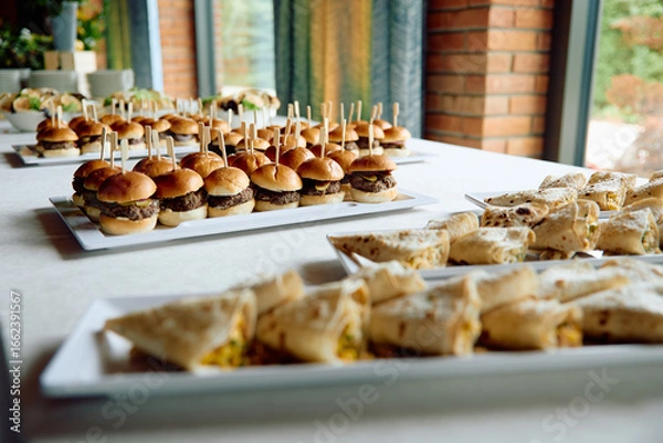 Fototapeta Mini burgers and wraps arranged for event catering