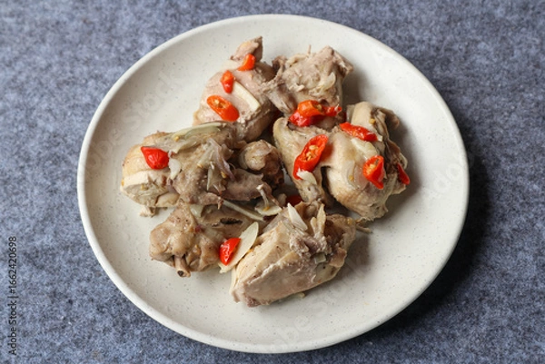 Fototapeta Steamed chicken served in a plate with various herbs and spices	