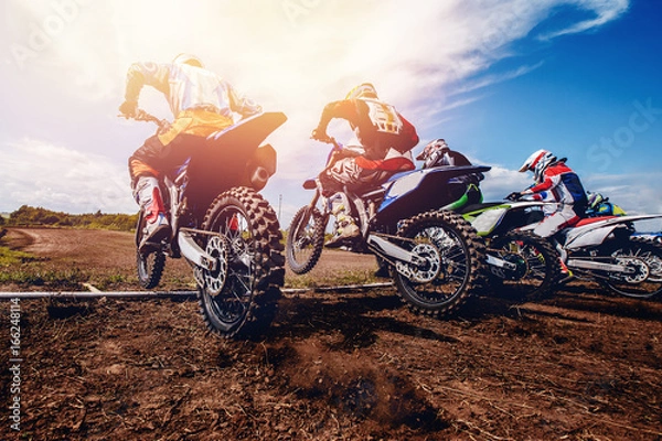 Obraz ekipa zawodników na rowerach górskich rusza, dym i kurz lecą spod kół nart biegowych. Koncepcja aktywnego wypoczynku motocross.