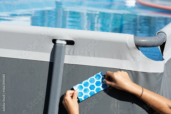 Fototapeta Apply patch on rubber swimming pool fixing or repair