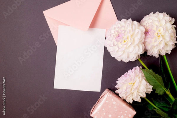 Obraz White and purple dahlias flowers and pink envelope with empty white card