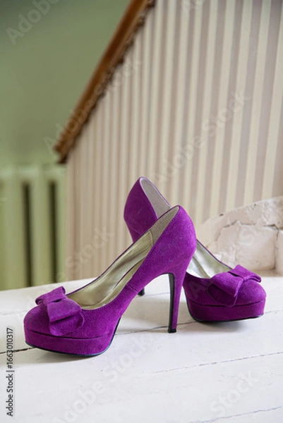 Obraz Purple high heels on a white floor background
