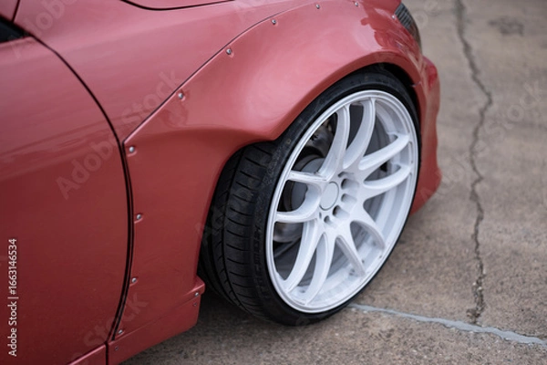 Fototapeta Detailed close-up of the front fender and widebody kit highlighting the bolted-on flares and low-profile wheel.