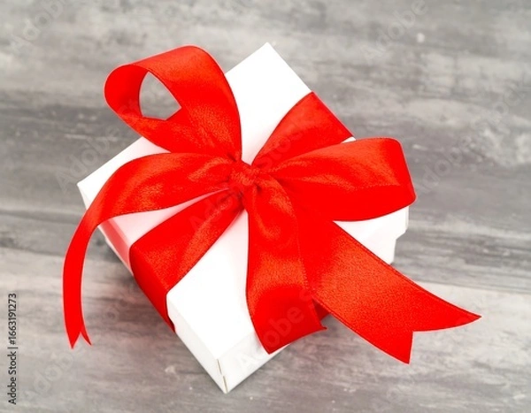 Obraz White gift box with red ribbon