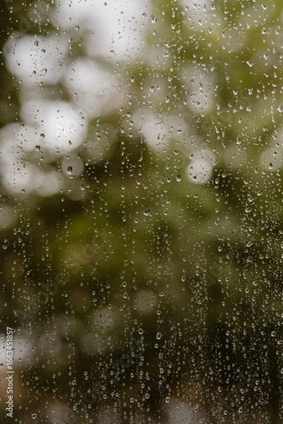 Obraz Raindrops on glass with bokeh background