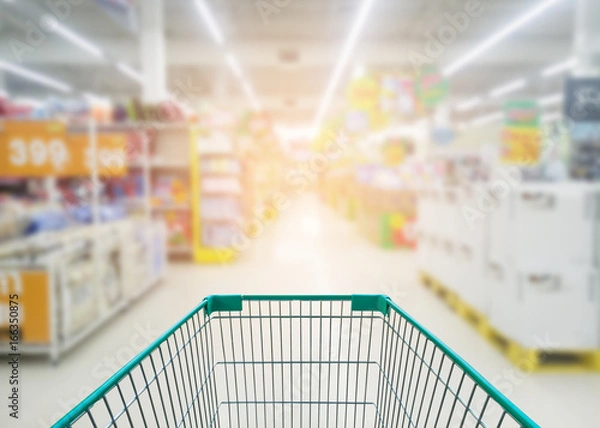 Obraz Supermarket store abstract blur background with shopping cart, Supermarket aisle with empty shopping cart