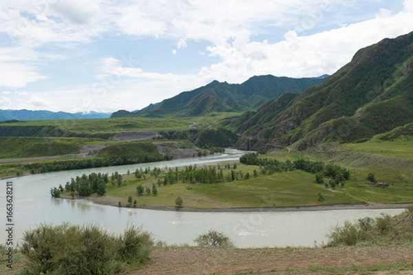 Fototapeta A stormy mountain river is muddy from clay washed down from the mountains.