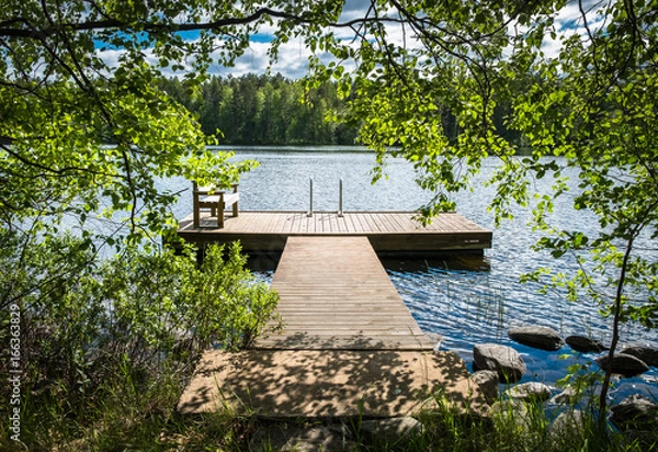 Obraz Idyllic lake view with pier at bright sunny summer day.