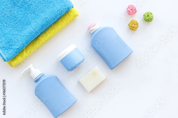 Fototapeta Bath accessories. Towels, soap, shampoo, lotion, cream on white background top view copyspace