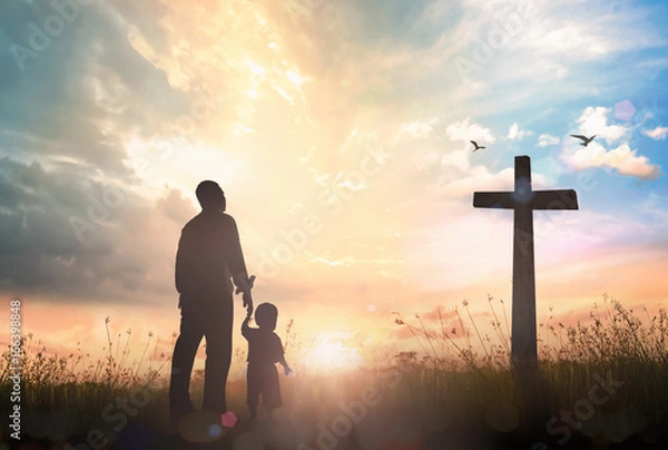 Obraz Resurrection of Easter Sunday concept: Silhouette father and son looking for the cross on meadow sunrise background.