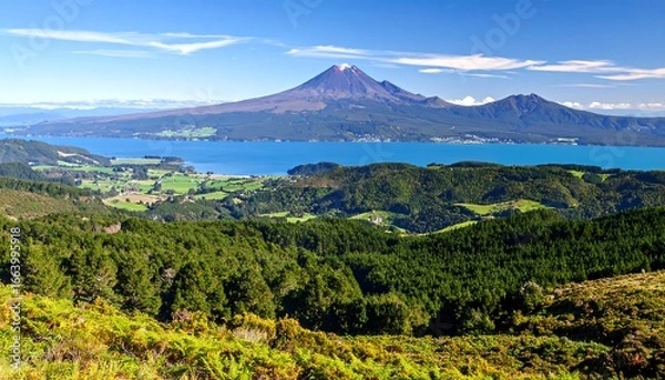 Fototapeta Stunning panoramic view of majestic mountain with a serene lake below