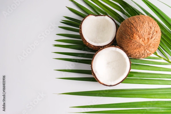 Fototapeta Coconut with half and leaves on white background