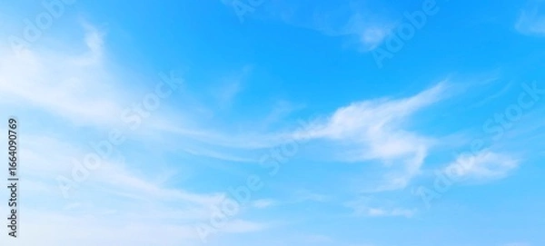 Fototapeta Panorama view of bright blue sky with fluffy white clouds on a clear sunny day. Sky panorama clear blue with white clouds in spring. Cloudscape. Clear blue sky, bright spring, wallpaper landscape.