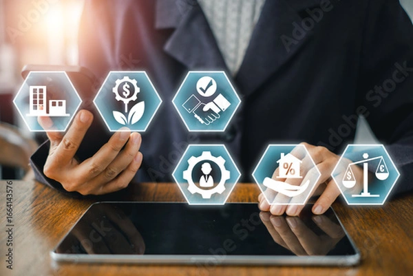 Fototapeta Businessman using digital icons to explore real estate investment trust strategies and financial growth on a tablet.