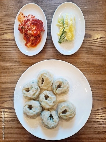 Fototapeta Korean steamed dumplings Mandu, traditional Korean fresh red Kimchi (Geotjeori) and white Kimchi which does not use red chili powder