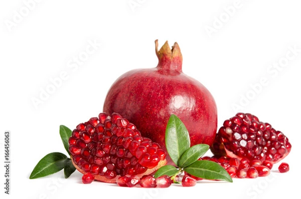 Fototapeta one whole and part of a pomegranate with pomegranate seeds and leaves isolated on white background