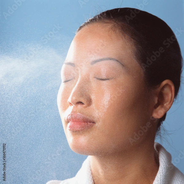 Obraz Water spraying on womans face