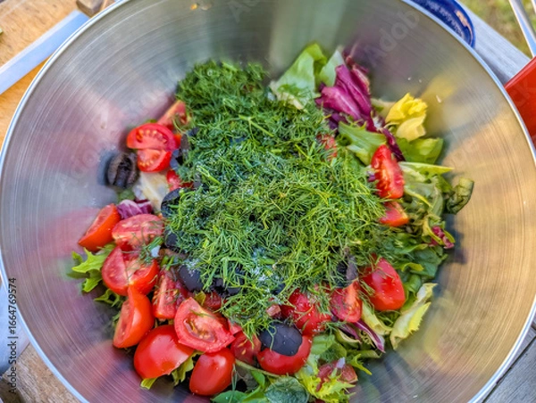 Fototapeta Colorful fresh salad with tomatoes and greens served in large bowl creating healthy meal presentation. High quality photograph