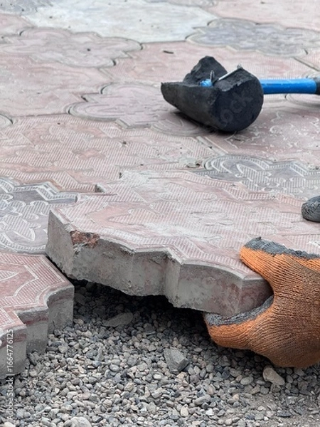 Fototapeta close up of laying paving stones the hands of a master in the process of work