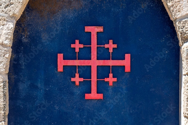 Fototapeta Close up of the Red Jerusalem Cross or Crusader Cross on the blue door of Saint John's Baptist Church in the old city of Acre, Akko Israel.
