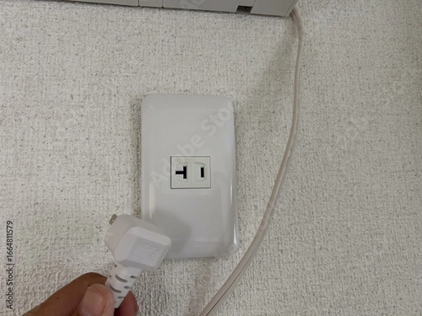 Fototapeta エアコンのそばにあるコンセント　電源　専用回路　電気工事　イメージ