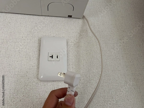 Fototapeta エアコンのそばにあるコンセント　電源　専用回路　電気工事　イメージ