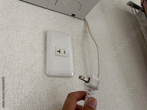 Fototapeta エアコンのそばにあるコンセント　電源　専用回路　電気工事　イメージ