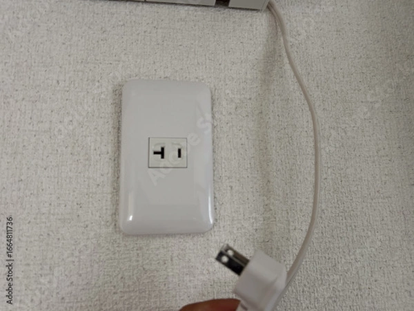 Fototapeta エアコンのそばにあるコンセント　電源　専用回路　電気工事　イメージ