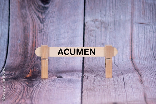 Fototapeta Acumen symbol. Single Wooden stick supported by Clothespins, beautiful Light Orange tone highlight Wooden Texture Background. Business and Acumen concept with copy space