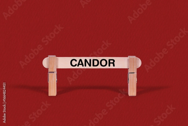 Fototapeta Candor symbol. Wooden stick braced by Clothespins, beautiful Red Background. Business and Candor concept with copy space