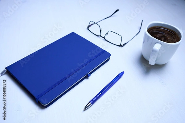Fototapeta notebook coffee and glasses on white table