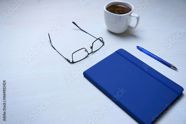 Fototapeta cup of coffee and notebook