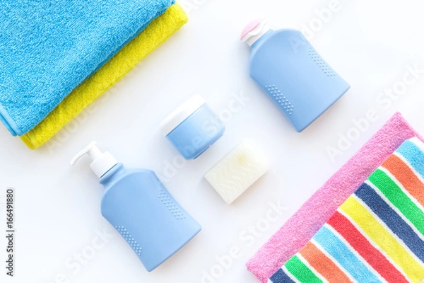 Fototapeta Bath accessories. Towels, soap, shampoo, lotion, cream on white background top view